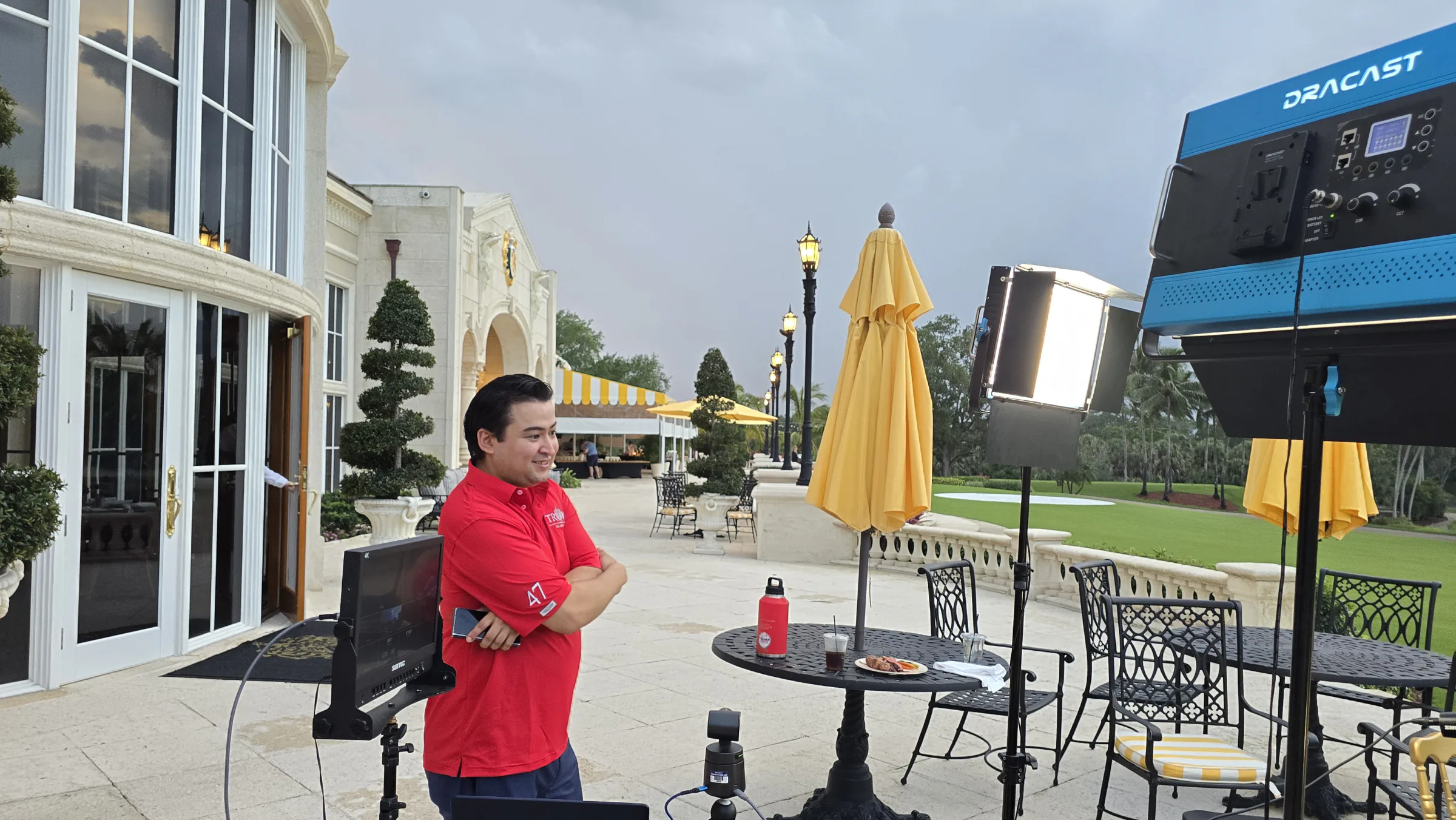 Ted Goodman stands beside production monitors and studio lights on the America’s Mayor Live patio set at Trump International